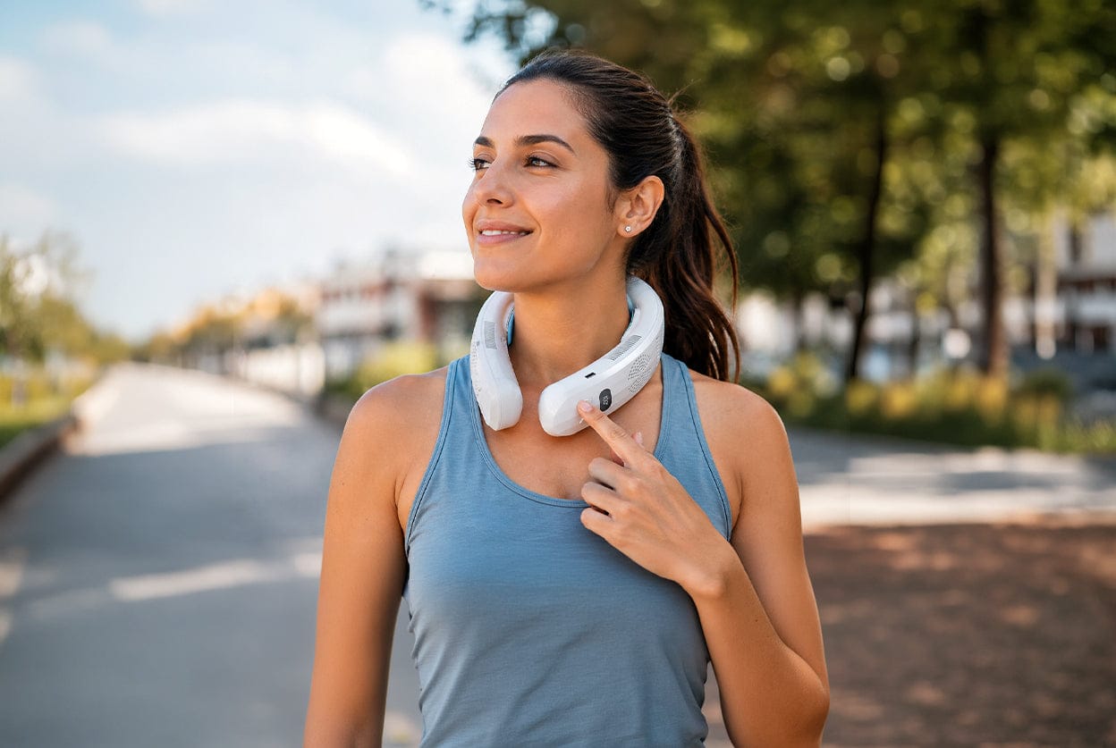 Woman wearing an AlphaCool bladeless neck fan outdoors