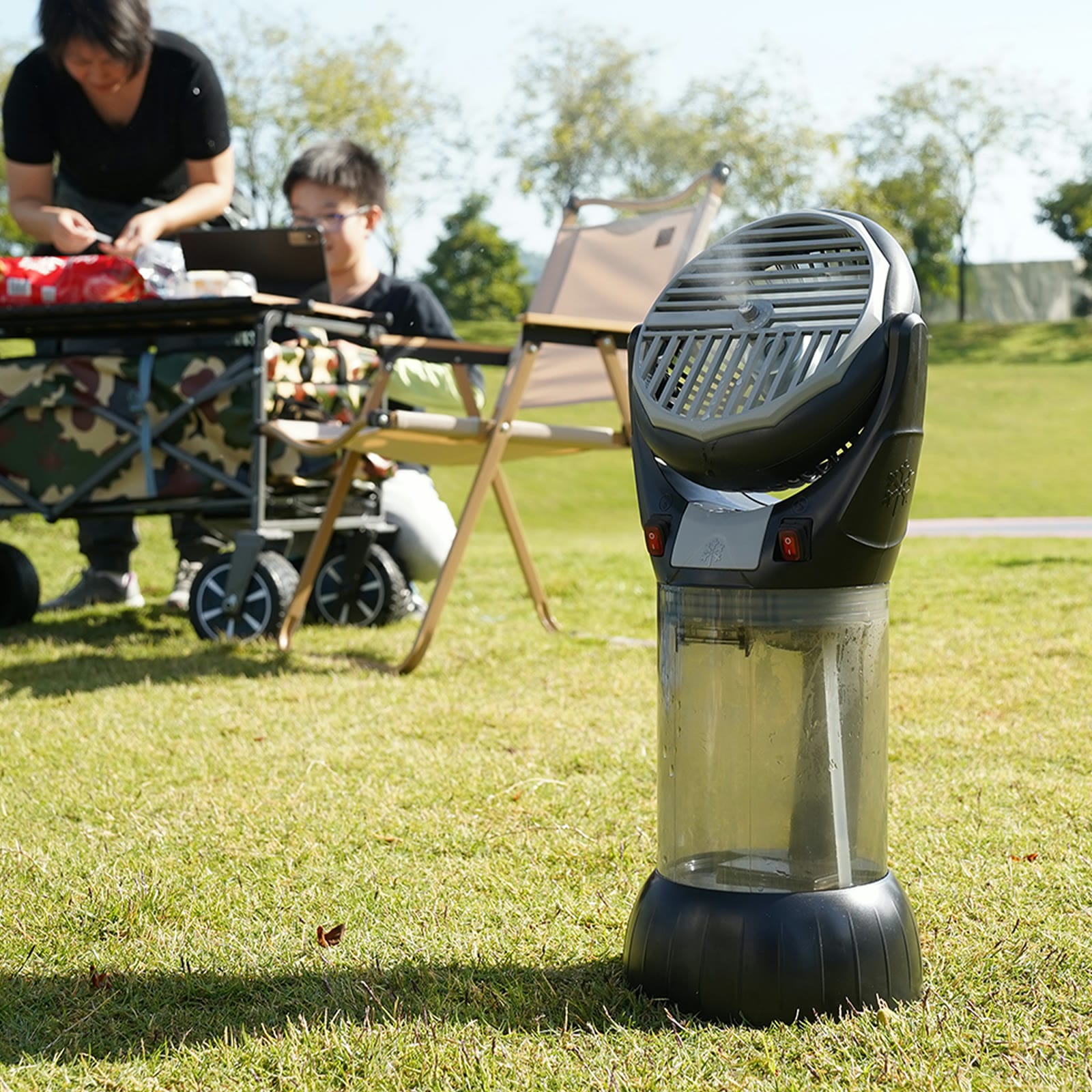 AlphaCool portable misting fan cooling a family picnic on the lawn